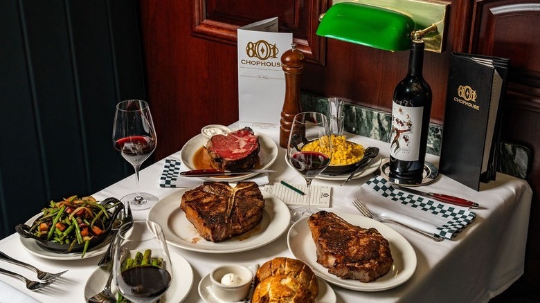 Various steaks and sides from 801 Chophouse on restaurant table.
