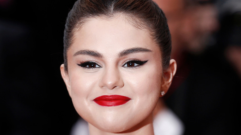 Selena Gomez wearing red lipstick