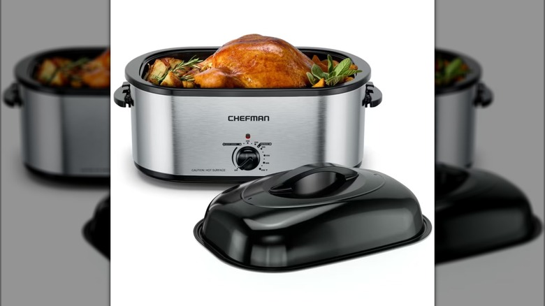 electric roaster with turkey and potatoes inside, lid off