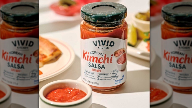 Bottle of Vivid Kitchen's kimchi salsa behind a small white bowl of it