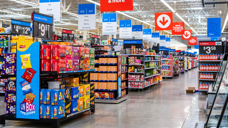 Endcaps at Walmart with product and signs above each aisle showing aisle numbers and what's in each