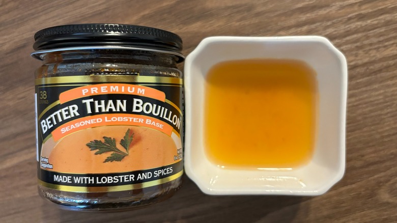 Better Than Bouillon Seasoned Lobster base in a jar and broth in a white ramekin
