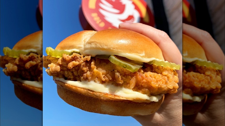 hands holding Church's Spicy Chicken sandwich 