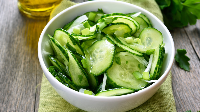 Bowl of thinly sliced cucumbers and white onions in vinegar