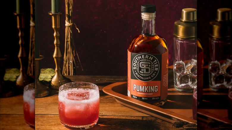 Bottle of Southern Tier Pumking on a tray with cocktail in glass