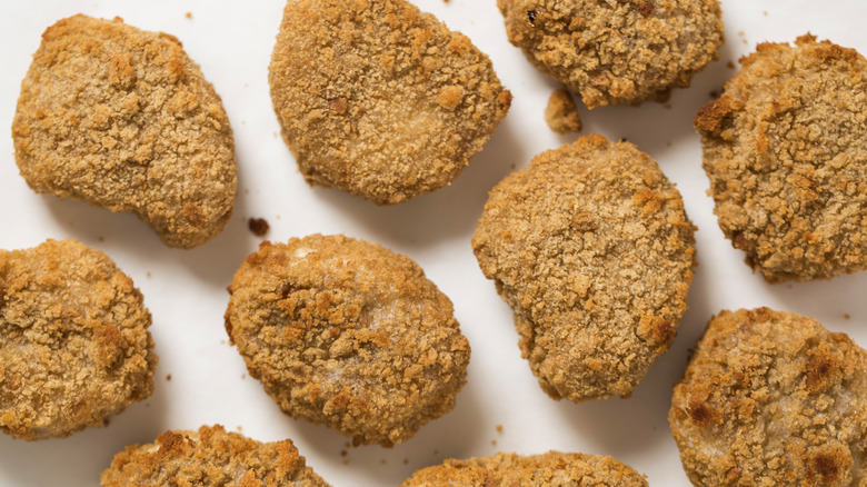 Close-up photo of chicken nuggets on a white background
