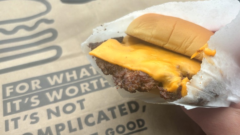 Shake Shack smash burger patty covered with melted American cheese in a potato bun