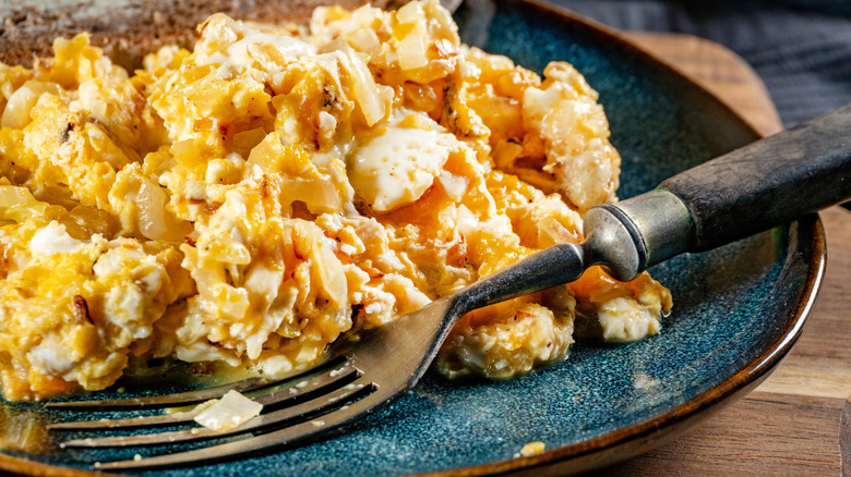 Plate of scrambled eggs with a fork