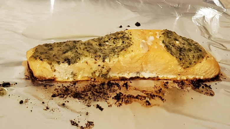 A cooked lemon butter salmon fillet on foil