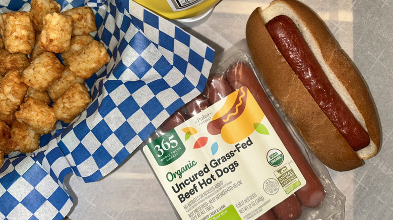Whole Foods hot dog package, hot dog and bun, and tater tots