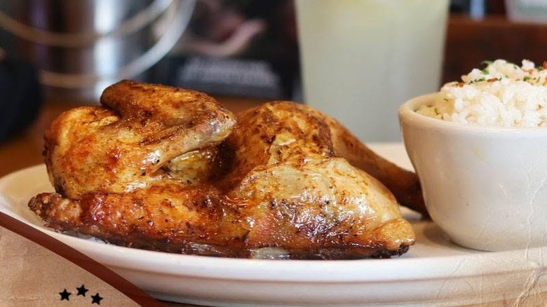 Oven-roasted half chicken and mashed potatoes on a platter at Texas Roadhouse