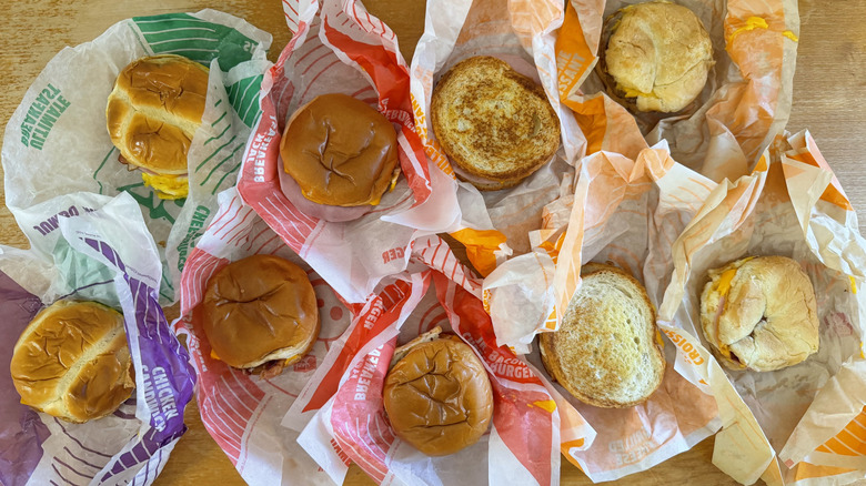 Top-down view of nine breakfast sandwiches in their wrappers