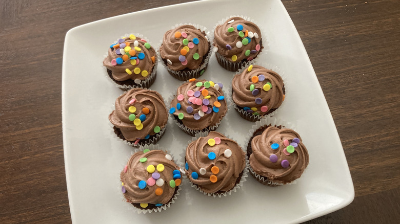 Kroger mini chocolate cupcakes on plate with chocolate icing and sprinkles