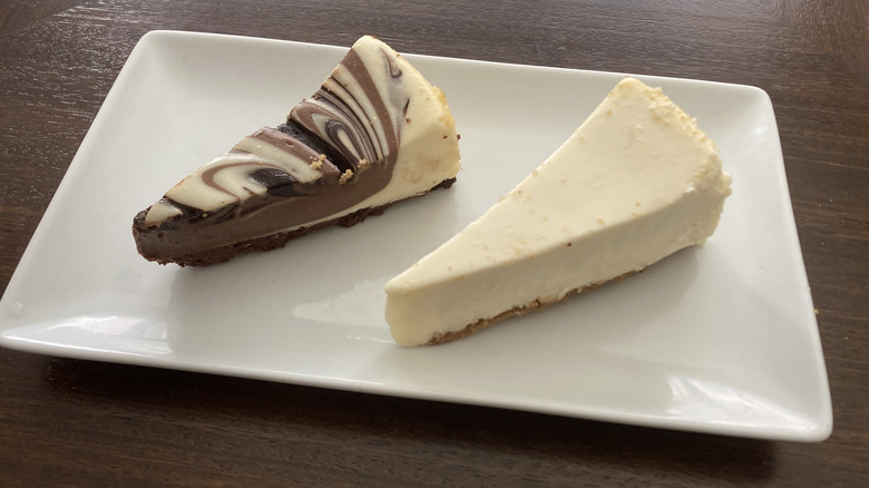 Kroger bakery cheesecake sampler slices on plate, one classic slice and one chocolate marble swirl slice