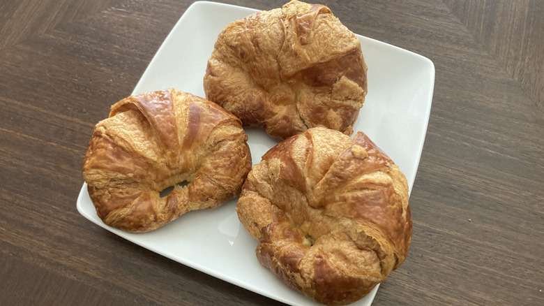 three Kroger croissants on white plate