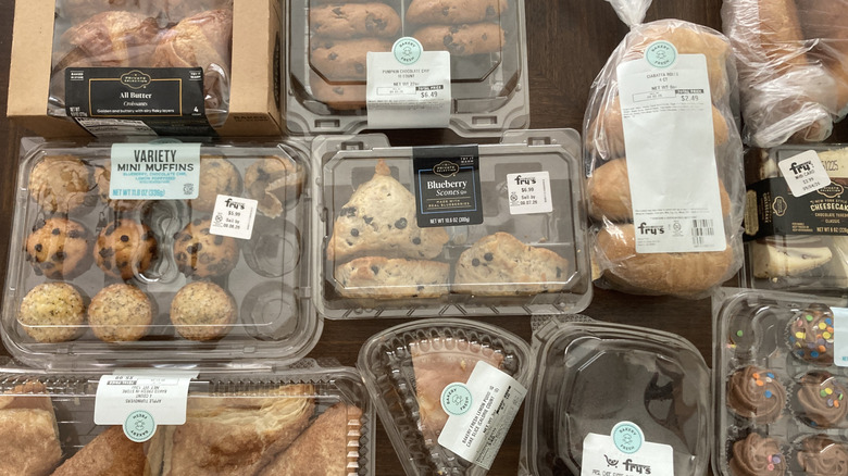 various Kroger bakery items in clear containers on table, including mini cupcakes and croissants