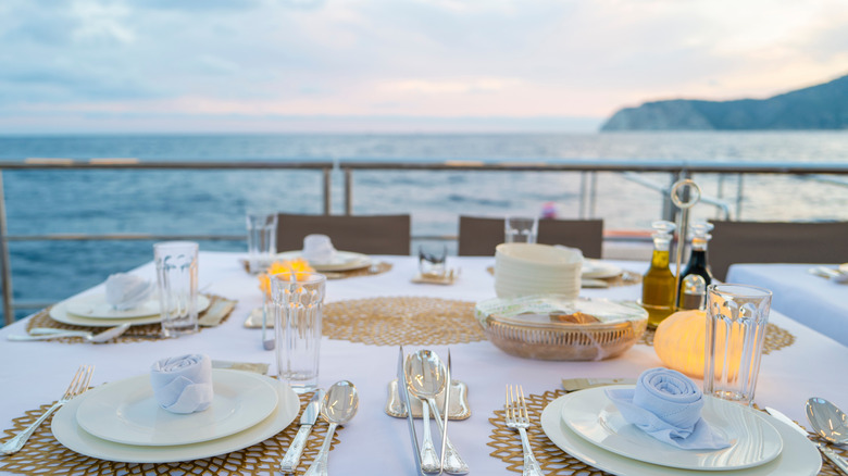 Set table on a yacht with ocean in background