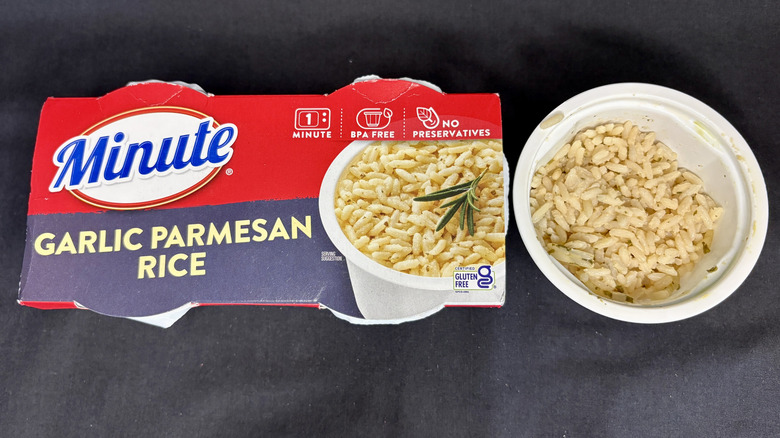 Bowl of rice next to Minute Garlic Parmesan Rice package