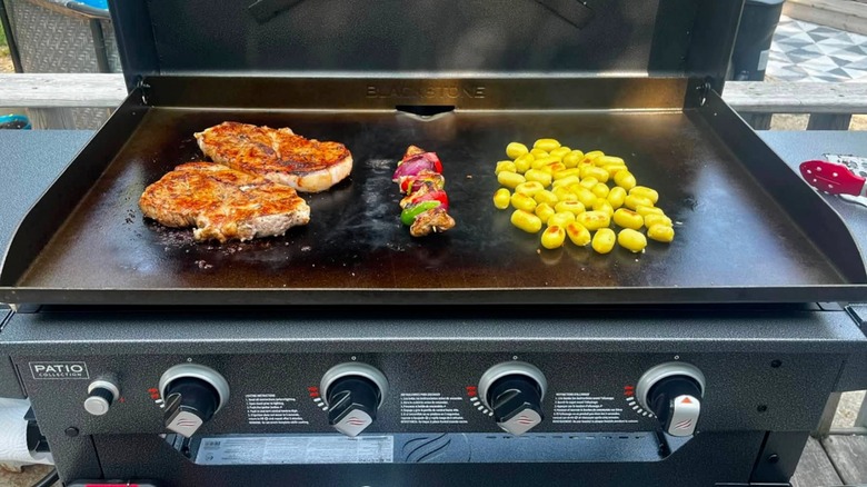 Steak, veggies, and dumplings being prepared on a Blackstone Griddle