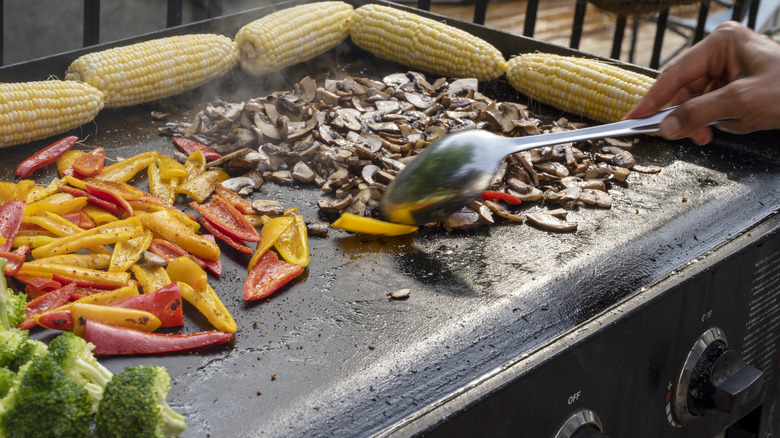 Flat top grill with corn, peppers, and mushrooms
