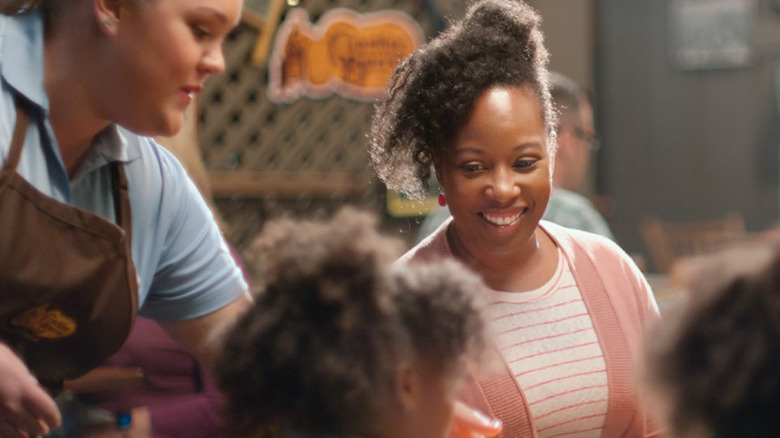 Woman dining with a child being served by a Cracker Barrel employee