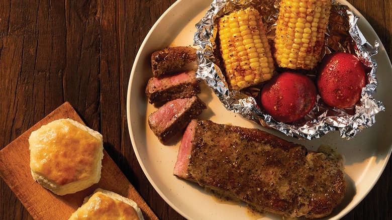 Seasonal option of a steak with corn and potatoes in a foil packet