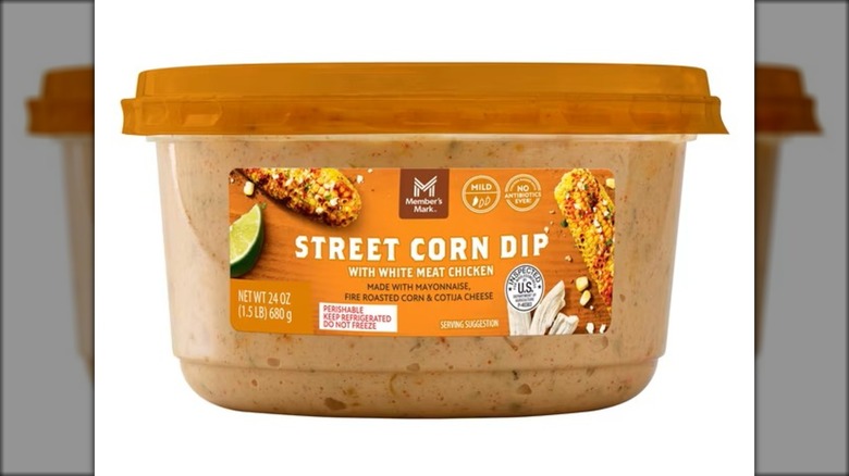 Container of street corn dip with chicken, roasted corn, and cheese.
