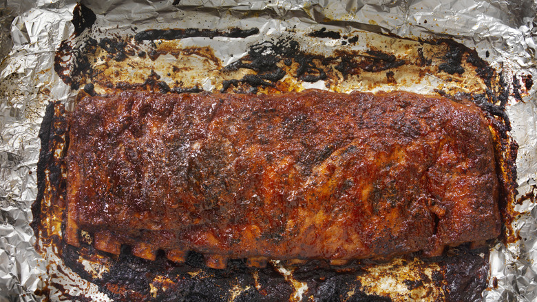 St Louis style baby back ribs unwrapped in aluminum foil after grilling