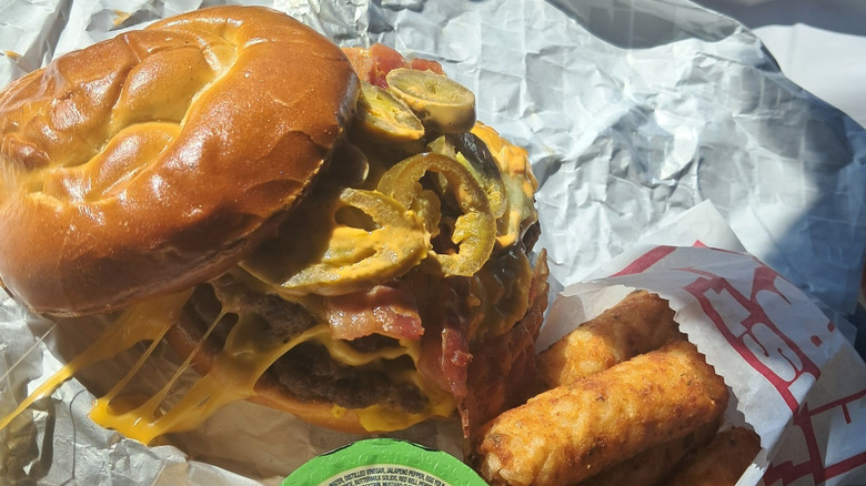 A Sheetz burger on a pretzel roll with mozzarella sticks