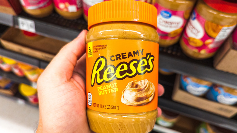 hand holding Reeses peanut butter