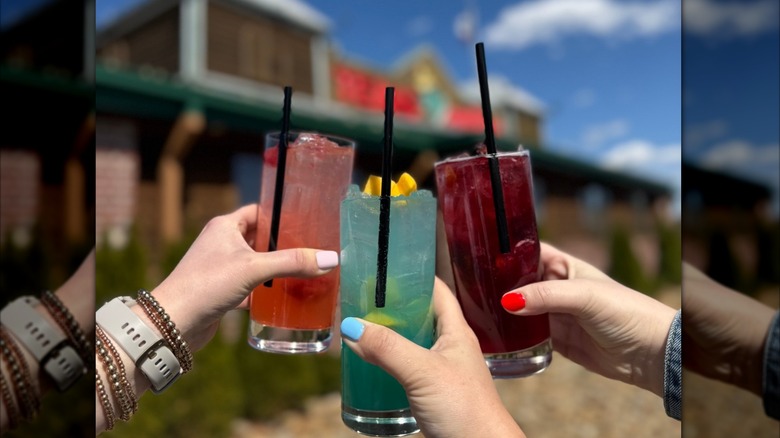 Clinking three cocktails outside of a Texas Roadhouse