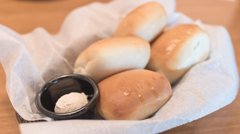 A basket of Texas Roadhouse rolls and butter