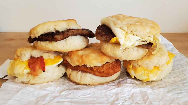 A stack of unwrapped Wendy's breakfast sandwiches
