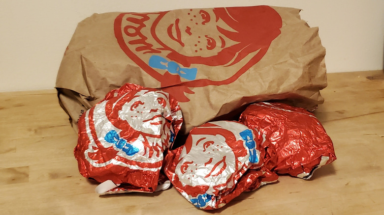 A bag of wrapped Wendy's breakfast sandwiches