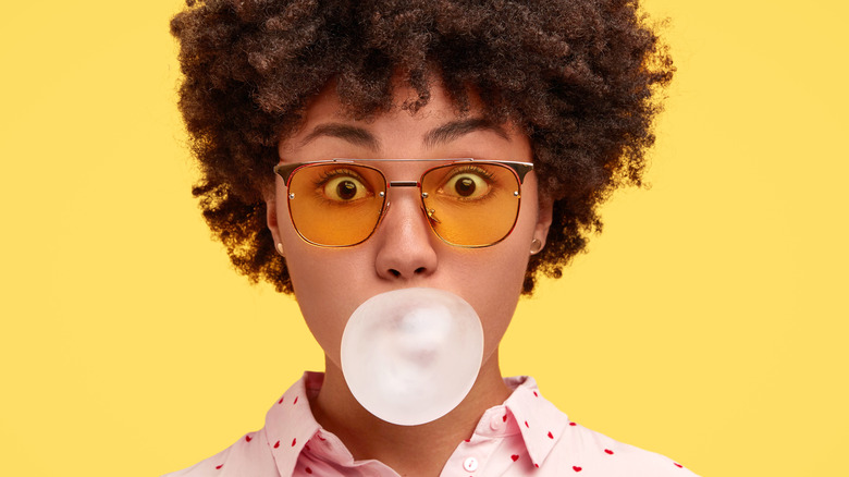 A woman blowing a gum bubble 