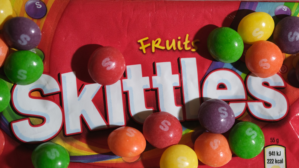 Skittles candy on top of Skittles bag