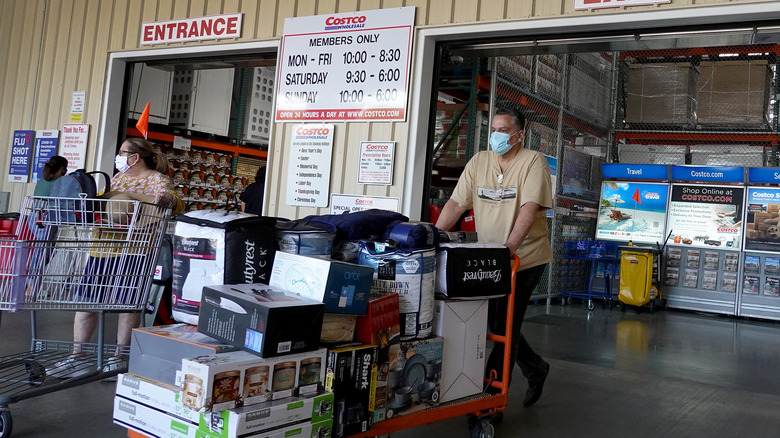Costco shopper with shopping carts