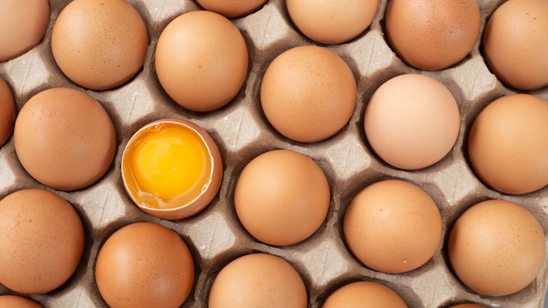 rows of eggs with one cracked