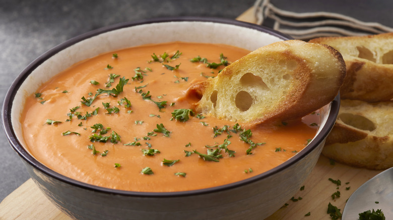 a bowl of tomato soup with crostini 