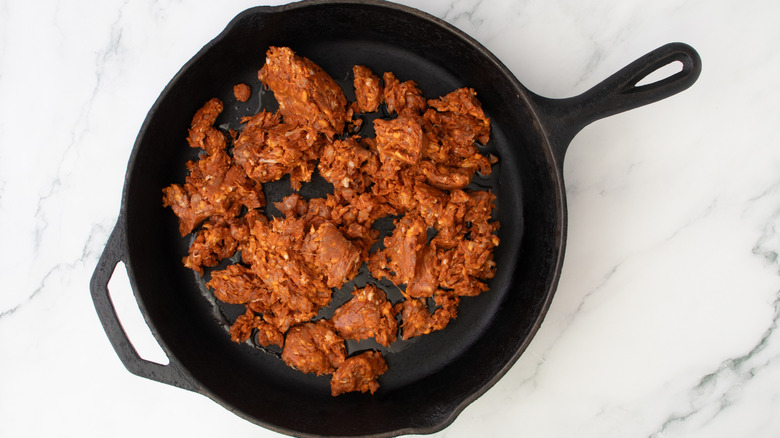 ground meat in black frying pan