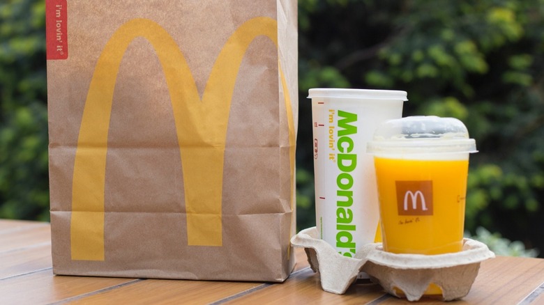 mcdonald's takeout bag with orange juice