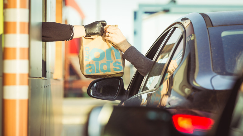 drive-thru worker handing over food