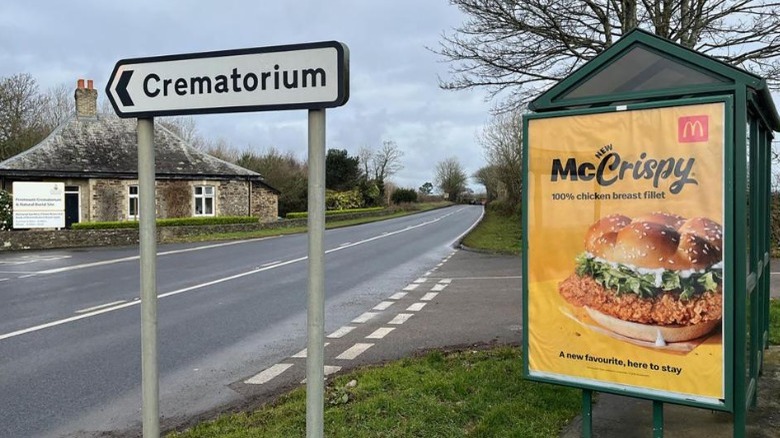 McCrispy ad next to crematorium sign