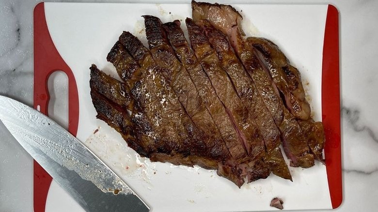 Sliced steak on cutting board