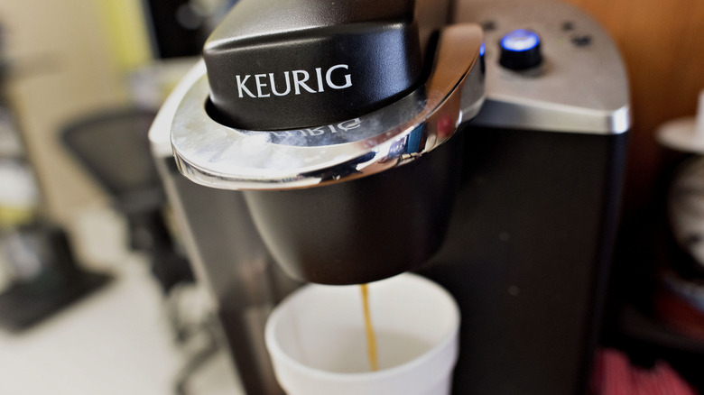 Keurig machine dispensing into coffee cup