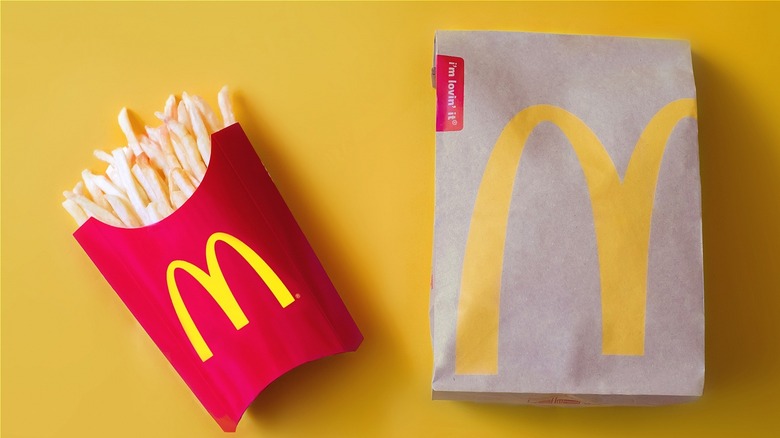McDonald's fries and packaging on yellow background
