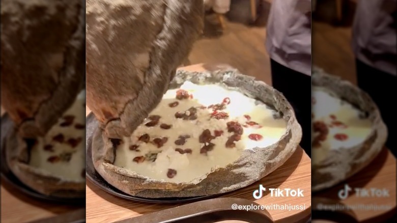 Pizza with domed crust being set on fire