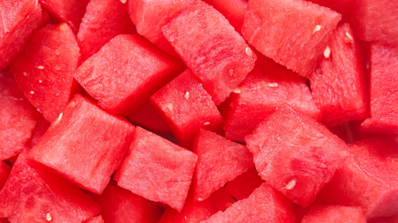 Cubes of watermelon with small white seeds.