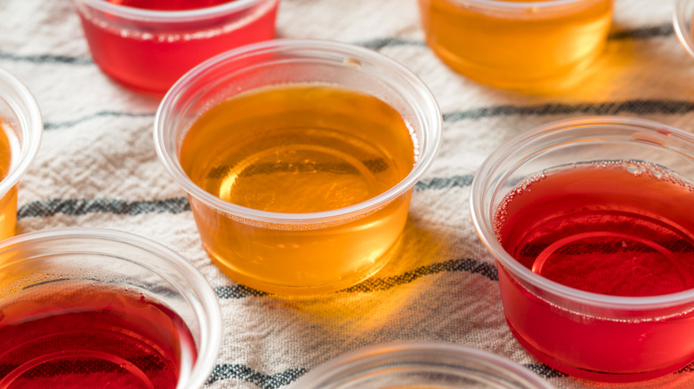Orange and red Jell-o shots in plastic cups