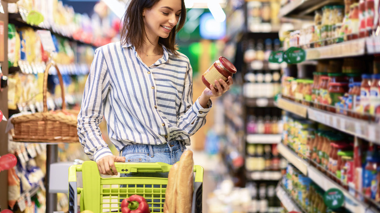 Woman filling grocery cart 